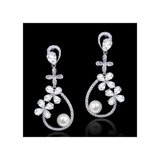 A beautifully elegant pair of drop earrings with modern styling. The design is made up of round ivory pearls and tiny CZ marquise crystals in a delicate vine arrangement, finished with a shimmering teardrop pearl. The perfect balance of sparkle and pearl the Belgravia earrings make a stylish complement to a classic or vintage-inspired bridal look.