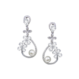 A beautifully elegant pair of drop earrings with modern styling. The design is made up of round ivory pearls and tiny CZ marquise crystals in a delicate vine arrangement, finished with a shimmering teardrop pearl. The perfect balance of sparkle and pearl the Belgravia earrings make a stylish complement to a classic or vintage-inspired bridal look.